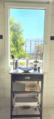 a table with a keyboard in front of a window at Spacious 3 room close to tram and amenities in Nice