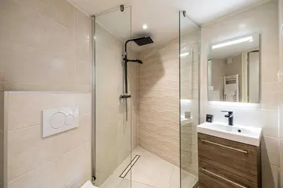 a bathroom with a glass shower and a sink at Residence Garibaldi - Nice in Nice