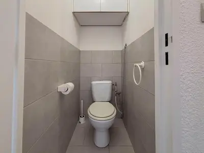 a bathroom with a white toilet in a stall at Douceur azuréenne - Wifi, Parking, vue mer, 4pers in Nice
