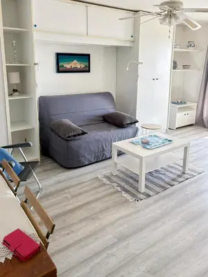 a living room with a couch and a coffee table at Douceur azuréenne - Wifi, Parking, vue mer, 4pers in Nice