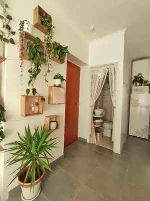 a room with a toilet and plants on the wall at Studio Jungle Bohème - à 3 min de la Promenade des anglais à pieds in Nice