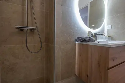 a bathroom with a shower with a sink and a mirror at Azzuro - Mare e Terrazza in Nice