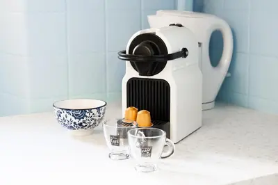 a coffee maker sitting on a counter with two cups at Nice Renting - 6C FRANCE - Chic Stay Pedestrian Zone Sea Massena in Nice