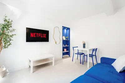 a living room with a blue couch and a table at Nice Renting - 6C FRANCE - Chic Stay Pedestrian Zone Sea Massena in Nice