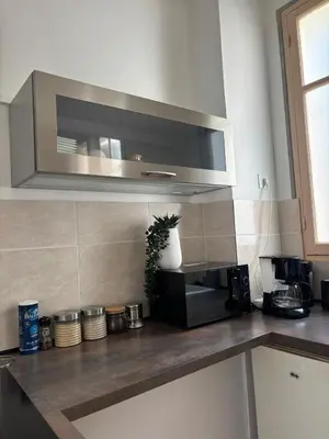 a kitchen with a counter top with a microwave at Studio proche gare in Nice