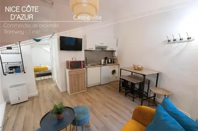a living room with a couch and a table at Studio 4 couchages in Nice