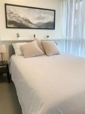 a bed with white sheets and pillows in a bedroom at Modern Studio by Port & Old Town in Nice