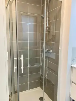 a shower with a glass door in a bathroom at Modern Studio by Port & Old Town in Nice