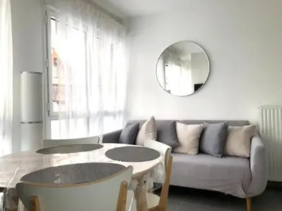 a living room with a couch and a table and a mirror at Modern Studio by Port & Old Town in Nice