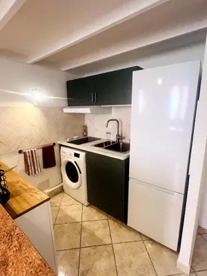 a kitchen with a white refrigerator and a dishwasher at Duplex Place Massena in Nice