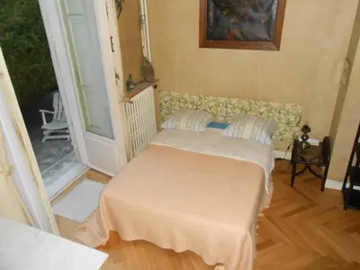 a living room with a couch and a balcony at Une chambre chez l'habitant a Nice - Cimiez in Nice