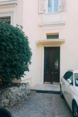 a car parked in front of a building with a door at Une chambre chez l'habitant a Nice - Cimiez in Nice