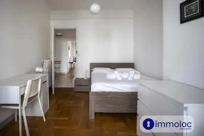 a bedroom with a bed and a table and a desk at Apartment neighborhood Liberation in Nice
