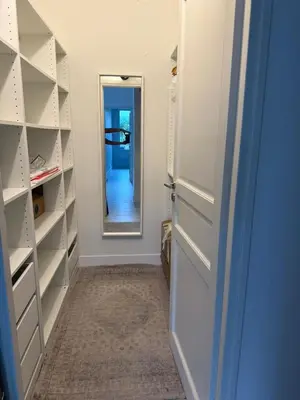a walk in closet with a door and a mirror at Beautiful 3 bedroom apartment with nice garden in Nice