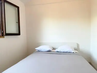 two white pillows sitting on a bed in a room at Charmant chalet avec jardin in Nice