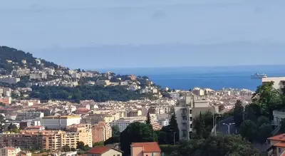 a view of a city with the ocean in the background at F2 vue mer et montagne au calme in Nice