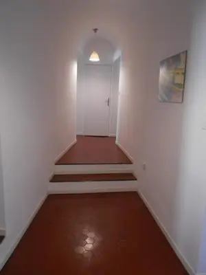an empty hallway with stairs and a white door at Exceptional Location Beaches Cours SALEYA in Nice