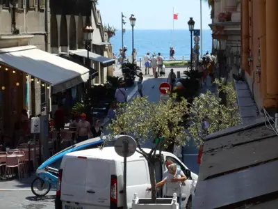 a woman standing next to a white van on a street at Exceptional Location Beaches Cours SALEYA in Nice