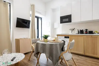 a living room with a couch and a table at WeHost D1 - Sea, Sauna & Sun - Studio 2pers in Nice