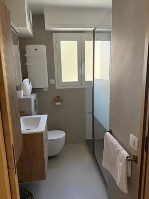 a small bathroom with a toilet and a sink at Le Cormoran bord de mer in Saint-Laurent-du-Var