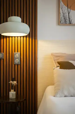 a bedroom with a bed and a lamp and a table at luxueux, spacieux dans le quartier du port in Nice