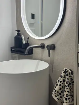 a bathroom with a white sink and a mirror at Central & Beach in Nice