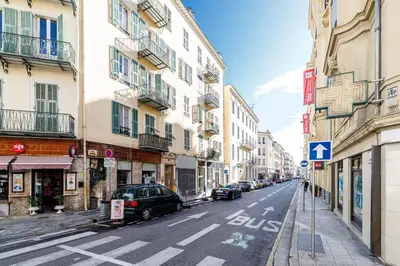 a street with cars parked on the side of a building at 44 LAMARTINE - Charmant 2 pieces - Centre-ville in Nice