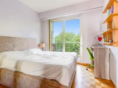 a bedroom with a bed and a large window at Apartment Le Sirius by Interhome in Nice