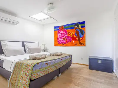 a bedroom with a bed and a painting on the wall at Holiday Home Les Genêts by Interhome in Nice