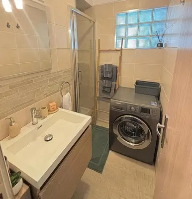 a bathroom with a washing machine and a sink at Cosy one bedroom apartment to Nice in Nice
