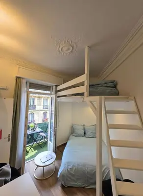 a bedroom with a bunk bed with a ladder at Cozy studio, balcony & AC, Heart of Nice in Nice