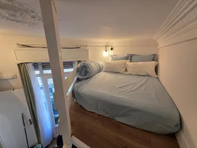 a large bed in a room with a window at Cozy studio, balcony & AC, Heart of Nice in Nice