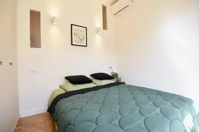 a bedroom with a large blue bed in a room at Nice Signature The Port in Nice