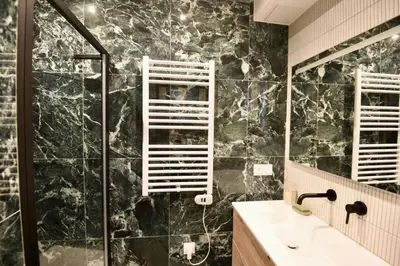 a bathroom with a shower and a sink and a mirror at Nice Signature The Port in Nice