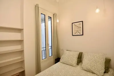a bedroom with a bed and a window and a mirror at Nice Signature The Port in Nice