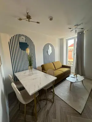 a living room with a couch and a table at MASSENA 42 in Nice