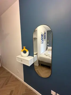 a room with a mirror and a bed in a room at MASSENA 42 in Nice