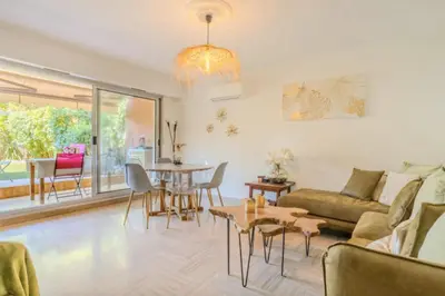 a living room with a couch and a table at Charming 80m for 6 people with garden in Cagnes-sur-Mer