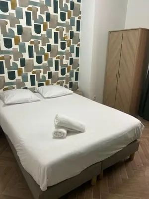 a bed with a white towel on top of it at MOON 26 - Appartement Nice 6P in Nice