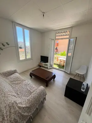 a living room with a bed and a table at Charmant et cosy 3pcs in Nice