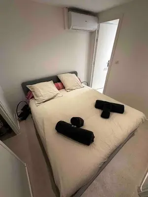 a bed with two black pillows on top of it at Palais Clerissy - Appartement 2 à 4 personnes centre ville Nice in Nice
