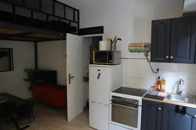 a small kitchen with a white refrigerator and a sink at Cozy apartment in Nice Est in Nice