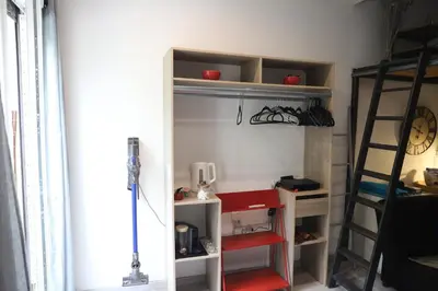 a room with a bunk bed and a ladder at Cozy apartment in Nice Est in Nice