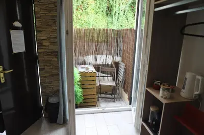 a door leading to a patio with a chair outside at Cozy apartment in Nice Est in Nice
