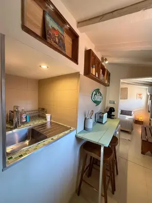 a kitchen with a sink and a counter with a table at Studio Place Rossetti - Old Nice Center in Nice