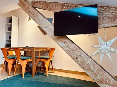 a living room with a wooden table and a tv at Cosy 2 pieces au Coeur du Centre Ville in Nice