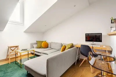 a living room with a couch and a tv at Cosy 2 pieces au Coeur du Centre Ville in Nice