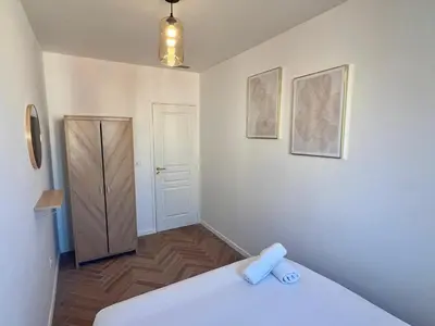 a room with a bed and a door and a door at MASSENA 27 in Nice