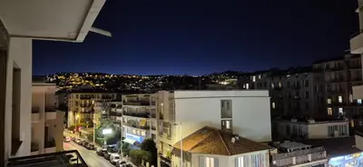 a view of a city at night with buildings at chambre privé chez l'habitant avec salle de bain privative in Nice