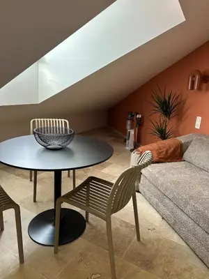 a living room with a table and a couch at Le Notre Dame in Nice
